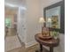 Welcoming entryway with wood floors, decorative mirror, table, and stylish accents at 5163 S River Rd, Lillington, NC 27546