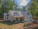 Charming craftsman-style home boasts a welcoming front porch, neat landscaping, and a well-maintained yard at 5163 S River Rd, Lillington, NC 27546