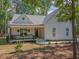 Beautiful home with a covered porch, manicured lawn, and picturesque curb appeal at 5163 S River Rd, Lillington, NC 27546