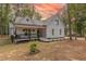 Charming exterior view of a two-story home with manicured landscaping and inviting front porch at 5163 S River Rd, Lillington, NC 27546