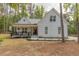 Charming exterior view of a two-story home with manicured landscaping and inviting front porch at 5163 S River Rd, Lillington, NC 27546
