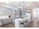 Charming kitchen with a large island, skylights, pendant lights, and gray cabinetry at 5163 S River Rd, Lillington, NC 27546