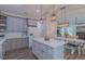 Modern kitchen featuring gray cabinets, quartz countertops, island, and open layout at 5163 S River Rd, Lillington, NC 27546