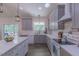 Bright kitchen featuring gray cabinets, white countertops, subway tile backsplash, and stainless steel appliances at 5163 S River Rd, Lillington, NC 27546