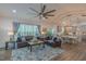 Spacious living room showcasing a dining area, cozy fireplace, large fan, and plenty of natural light at 5163 S River Rd, Lillington, NC 27546