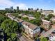 Aerial view of a townhome community surrounded by lush greenery and the city skyline in the distance at 531 N Person St # 205, Raleigh, NC 27604
