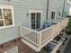View of a private balcony with white railing, offering an outdoor living space, and featuring an AC unit at 531 N Person St # 205, Raleigh, NC 27604