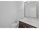 Clean and modern half bathroom with a stylish vanity, mirror, and fixtures, perfect for guests at 531 N Person St # 205, Raleigh, NC 27604
