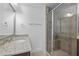 Bathroom featuring a granite vanity, shower with glass door and tiled surround at 531 N Person St # 205, Raleigh, NC 27604