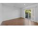 Bright bedroom with hardwood floors, ample natural light, and access to a private balcony for relaxation at 531 N Person St # 205, Raleigh, NC 27604