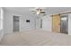 Bright bedroom featuring neutral carpet, ceiling fan, sliding barn door, and closet at 531 N Person St # 205, Raleigh, NC 27604