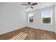 Bright bedroom with a ceiling fan, wood-look floors, two windows, and neutral decor at 531 N Person St # 205, Raleigh, NC 27604