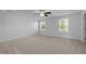 Spacious bedroom with carpet flooring, ceiling fan, and natural light streaming through the bright windows at 531 N Person St # 205, Raleigh, NC 27604