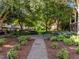 Community courtyard features lush plantings, paved pathways, and seating areas, creating a serene environment at 531 N Person St # 205, Raleigh, NC 27604