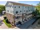 Charming townhome exterior features brick accents, private balconies, and convenient garage access from street at 531 N Person St # 205, Raleigh, NC 27604