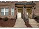 Charming brick townhome entrance with inviting steps and well-maintained landscaping at 531 N Person St # 205, Raleigh, NC 27604