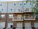 Exterior shot of townhomes shows a brick base, multiple balconies, and individual garage entrances at 531 N Person St # 205, Raleigh, NC 27604