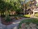 Serene walkway lined with benches and lush greenery, leading to charming brick townhomes at 531 N Person St # 205, Raleigh, NC 27604