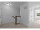Well-lit hallway featuring carpet flooring and a staircase with a wooden handrail and white spindles at 531 N Person St # 205, Raleigh, NC 27604