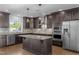Spacious kitchen featuring granite countertops, stainless steel appliances, a center island, and hardwood floors at 531 N Person St # 205, Raleigh, NC 27604