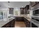Spacious kitchen featuring granite countertops, stainless steel appliances, a center island, and hardwood floors at 531 N Person St # 205, Raleigh, NC 27604