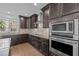 Spacious kitchen featuring granite countertops, stainless steel appliances, a center island, and hardwood floors at 531 N Person St # 205, Raleigh, NC 27604