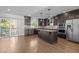 Spacious kitchen featuring granite countertops, stainless steel appliances, a center island, and hardwood floors at 531 N Person St # 205, Raleigh, NC 27604