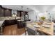 Stylish kitchen features an island, stainless steel appliances, wood floors and a dining area at 531 N Person St # 205, Raleigh, NC 27604