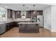 Spacious kitchen featuring granite countertops, stainless steel appliances, a center island, and hardwood floors at 531 N Person St # 205, Raleigh, NC 27604
