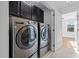 Convenient laundry room with modern washer and dryer, accompanied by cabinetry for storage at 531 N Person St # 205, Raleigh, NC 27604