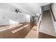 Spacious living room with hardwood floors, ceiling fan, and staircase leading to the second floor at 531 N Person St # 205, Raleigh, NC 27604