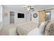 Bright main bedroom boasts a ceiling fan, TV, barn door and decorative mirror at 531 N Person St # 205, Raleigh, NC 27604