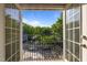 Scenic view from a balcony overlooking a quiet street with lush greenery and charming neighborhood houses at 531 N Person St # 205, Raleigh, NC 27604