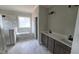 Luxurious bathroom with a soaking tub, walk-in shower, and dual vanity sinks with quartz countertops at 55 Stream View Way, Spring Hope, NC 27882