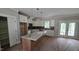Modern kitchen featuring an island, stainless appliances, white cabinets, and a window view at 55 Stream View Way, Spring Hope, NC 27882