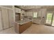 Bright kitchen with island, granite counters, custom cabinets, and stainless sink at 55 Stream View Way, Spring Hope, NC 27882