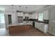 Modern kitchen with white cabinets, a center island, stainless steel appliances, and stylish pendant lighting at 55 Stream View Way, Spring Hope, NC 27882
