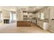Bright kitchen with island, granite counters, custom cabinets, and stainless sink at 55 Stream View Way, Spring Hope, NC 27882