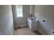 Bright laundry room with a window, utility sink, shaker cabinets and washer/dryer hookups at 55 Stream View Way, Spring Hope, NC 27882