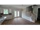 Open living area with backyard access, next to modern kitchen with great lighting at 55 Stream View Way, Spring Hope, NC 27882