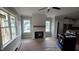 Bright living room with a modern fireplace, large windows, and wood flooring at 55 Stream View Way, Spring Hope, NC 27882