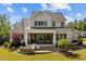 Spacious backyard with lush lawn, outdoor seating, grilling area, and covered patio for seamless indoor-outdoor living at 623 Westfall Way, Chapel Hill, NC 27517