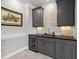 Stylish bar area with wine fridge, ample cabinetry and modern finishes at 623 Westfall Way, Chapel Hill, NC 27517