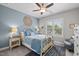 Comfortable bedroom featuring a ceiling fan, and an ornate metal bed frame and decorative wall art at 623 Westfall Way, Chapel Hill, NC 27517