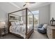 Bright bedroom with a four poster bed, comfortable seating and natural light at 623 Westfall Way, Chapel Hill, NC 27517
