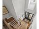 High-angle view of the foyer showcases the hardwood floors, staircase, and entry with transom window at 623 Westfall Way, Chapel Hill, NC 27517
