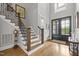 Elegant foyer with hardwood floors, staircase, and stylish front door creates a welcoming entrance at 623 Westfall Way, Chapel Hill, NC 27517