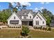 Beautiful home featuring a stone and siding facade, manicured lawn, and a welcoming front porch at 623 Westfall Way, Chapel Hill, NC 27517