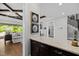 Kitchen featuring a granite countertop island, dark cabinetry and open access to the living room at 623 Westfall Way, Chapel Hill, NC 27517