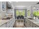 Well-appointed kitchen featuring stone countertops, stainless appliances, and access to the dining area at 623 Westfall Way, Chapel Hill, NC 27517